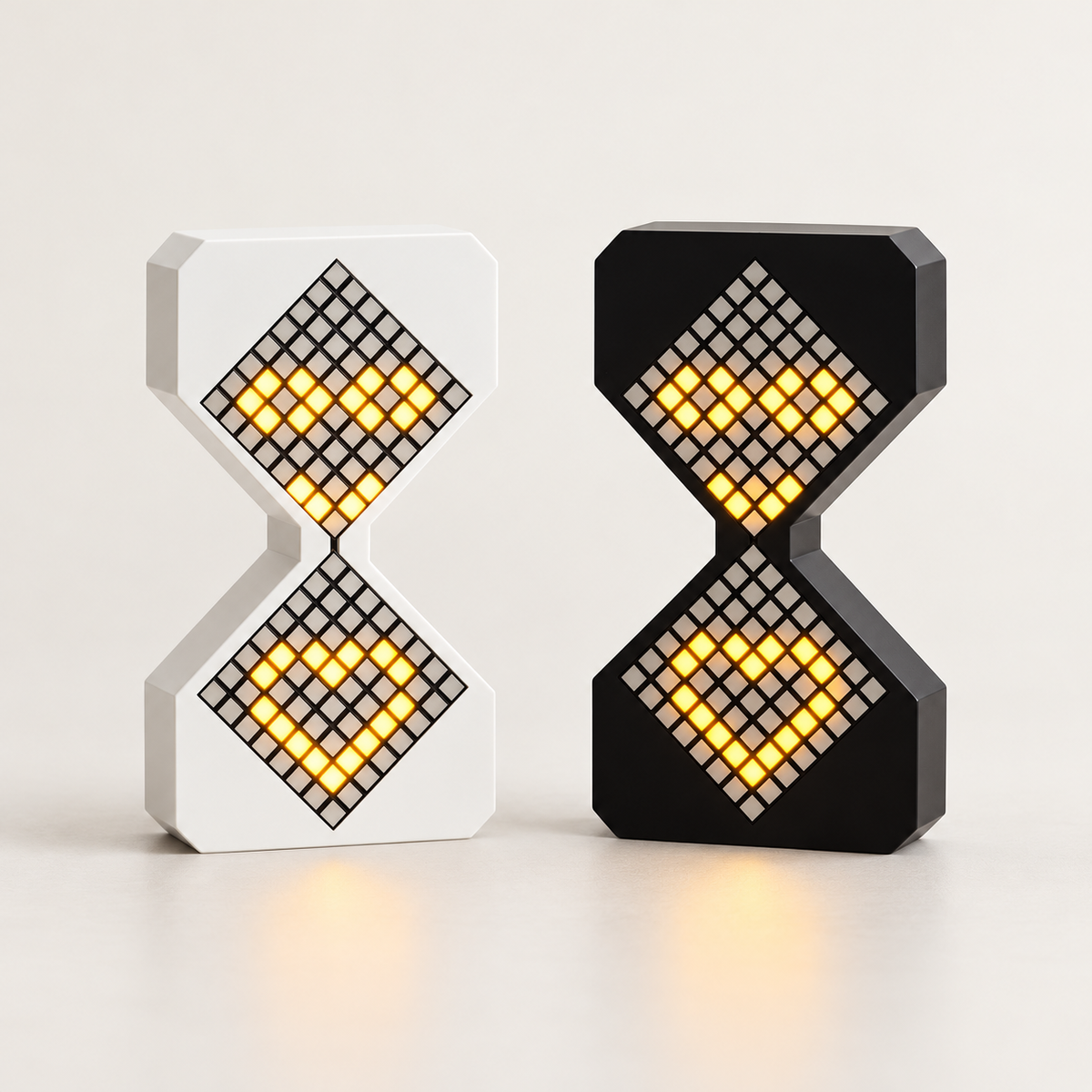Black and white Tovi LED hourglass night lights illuminated together